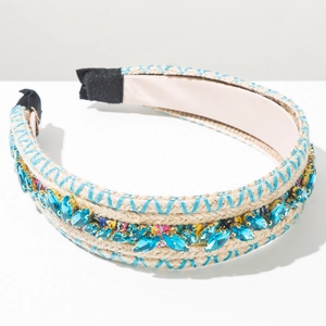 Detail of woven straw headband featuring light blue crystals and golden bead accents