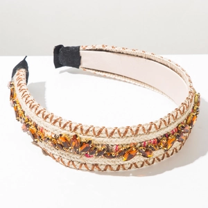 Close-up of woven headband with amber marquise crystals and fabric ear guards