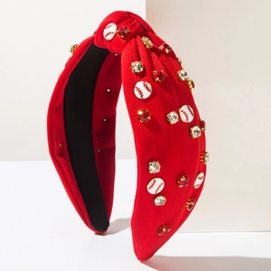 Macro detail of red knotted baseball headband with rhinestones and themed emblems