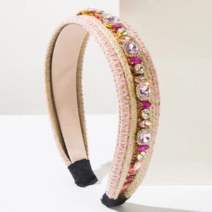 Detail of bohemian knit headband with pink rhinestones and braided texture