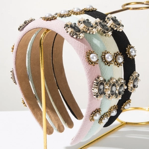 Detail of vintage fabric headbands with pearls, rhinestones and textured weave patterns