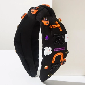 Detail of Halloween headband featuring handmade pumpkin ghost and TRICK beadwork embroidery
