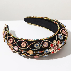 Detailed close-up of velvet headband with luxury colorful rhinestone floral embroidery