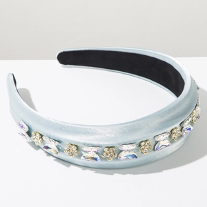 Détail d'un serre-tête en satin bleu clair avec papillon scintillant et décor floral