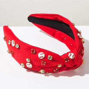 Detail of red knotted baseball headband with rhinestone accents and enamel charms