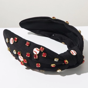Close-up of black knot headband with sparkling rhinestones and baseball charm details