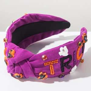 Macro shot of Halloween headband with beaded TRICK lettering, ghost and pumpkin charms