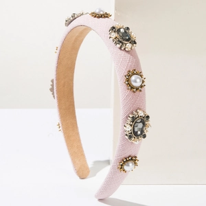 Detail showing pink fabric headband with vintage floral rhinestones and pearl embellishments