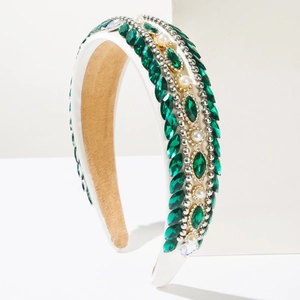 Detail of vintage baroque headband with green crystals, pearls and rhinestone chains