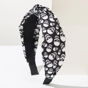 Halloween headband with black and white skull pattern and stylish top knot design