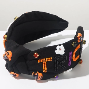 Detail of beaded TRICK text and ghost pumpkin charms on a Halloween headband