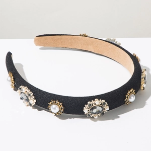 Detail of black fabric headband with faux pearls and grey crystals in gold settings