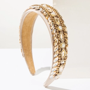 Detailed macro view of luxury baroque headband with crystals and pearls on champagne satin