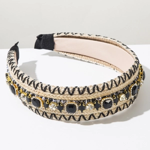Detailed view of bohemian woven headband with black embroidery and sparkling gemstones