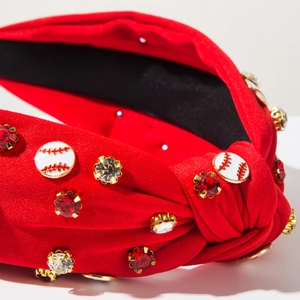 Detail of red fabric knotted headband with baseball charms and rhinestones