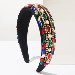 Close-up of luxury Baroque headband with colorful rhinestones and pearls on black velvet