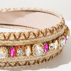 Detail of bohemian woven headband with hand-stitched threads and colorful crystals