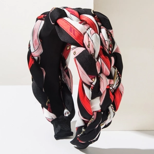 Close-up of bohemian wide braided headband with vintage geometric chain print pattern