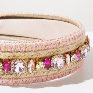 Close-up of bohemian knitted headband featuring pink crystals and manual embroidery detail