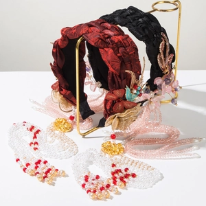 Detail of vintage Chinese braided headband set with floral charms and long beaded tassels