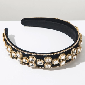 Macro shot of luxury velvet headband with emerald-cut white rhinestones on gold base