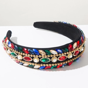 Close-up of Baroque headband with colorful rhinestones, pearls and golden bead chains