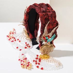 Close-up of red braided silk headband with golden phoenix and white beaded tassels