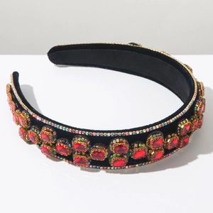 Detail of luxury baroque velvet headband featuring large red rhinestones and fine crystals