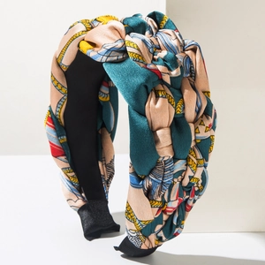 Detail showing vintage geometric chain patterns on silk-textured twisted headband