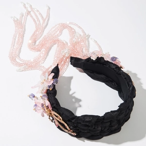 Detail of woven headband with rhinestone butterfly and long pink beaded tassels
