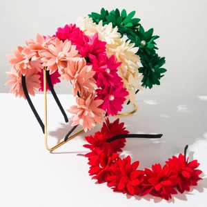 Detailed close-up of colorful fabric flower headbands with central pearl embellishments