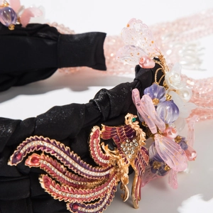 Detailed close-up of a Phoenix golden ornament with rhinestones and beads on a headband
