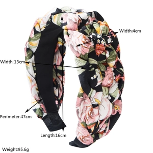 Close-up of braided floral headband showing detailed pink flower patterns and dimensions