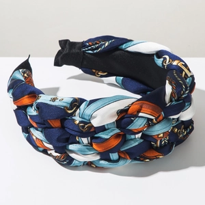 Detail of bohemian braided headband featuring vintage chain prints and satin texture