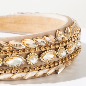 Macro detail of champagne crystal and pearl embroidery on wide baroque headband