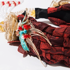 Detailed shot of handmade braided headband with golden phoenix and floral jewelry