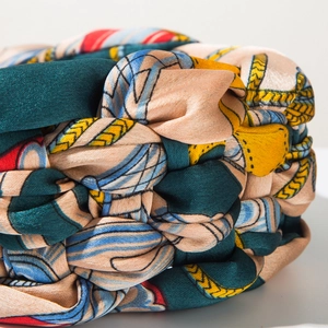 Macro view of Bohemian braided headband featuring vintage chain patterns and silk texture