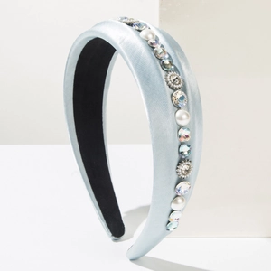 Detail of light blue satin headband with hand-sewn pearls and sparkling rhinestones
