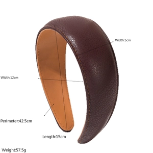 Detail shot of wide brown PU leather headband showing size dimensions and lychee texture