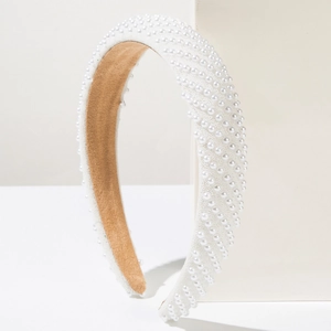Detailed side view of luxury wide headband featuring white pearls and non-slip suede lining