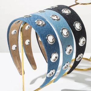 Close-up of denim headbands with silver metal eyelets and soft velvet lining texture