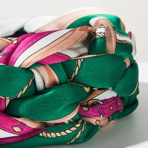 Macro detail of Bohemian braided headband featuring vintage chain print and silk texture