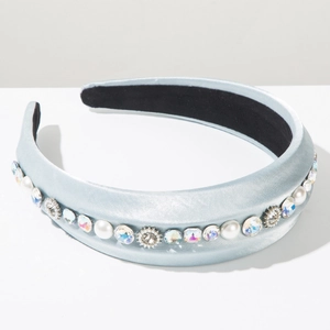 Detailed macro view of light blue satin headband with pearls and sparkling rhinestones