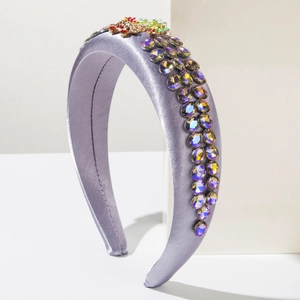 Close-up of purple satin headband featuring intricate rhinestone inlay and jewelry details