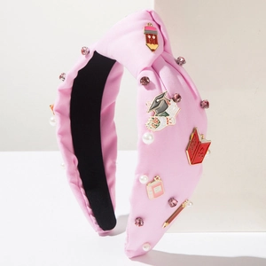 Pink school themed knotted headband with pencil and book charms and faux pearls