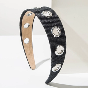 Close-up of black denim wide headband featuring silver metal eyelets for a punk aesthetic