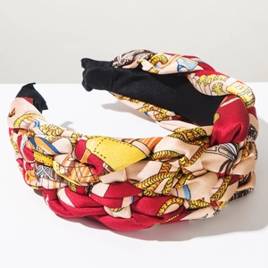 Close-up of multicolored braided headband with chain print and silk texture fabric