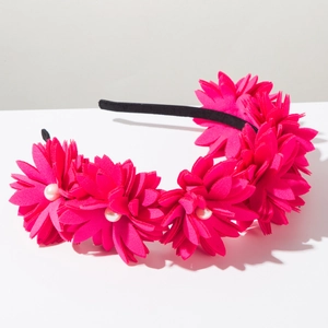 Detailed view of layered rose red fabric flowers and white pearls on the fashion headband