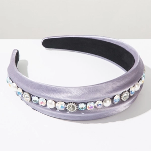 Detail of lavender satin headband with faux pearls and rainbow rhinestones on white