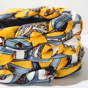 Macro shot of silk satin braided headband with yellow, blue and white chain prints